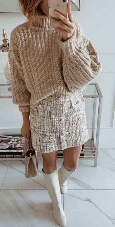 an all neutrla outfit with a creamy oversized chunky jumper, a white tweed mini, white knee boots and a grey mini bag