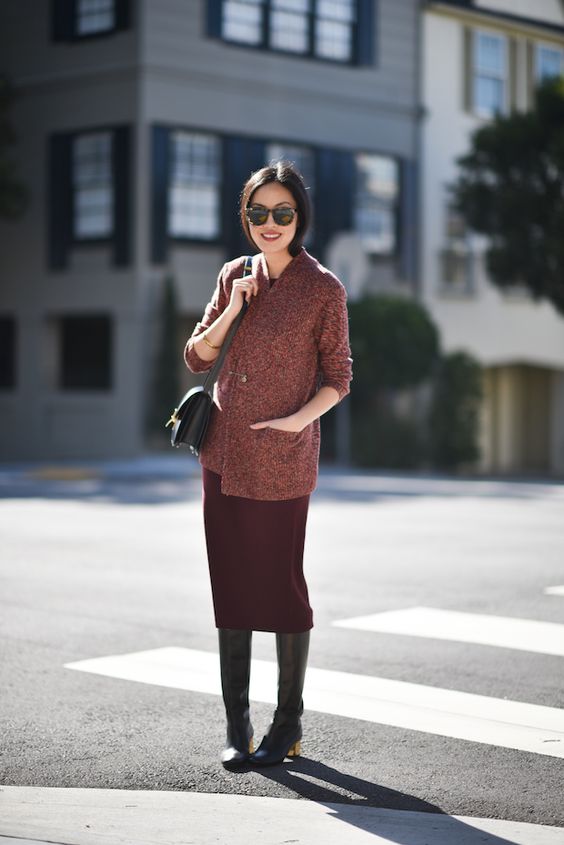a fall or winter look with a burgundy straight midi, black boots, a red printed cropped coat and a black bag