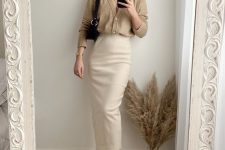 19 a neutral look with a tan cardigan as a shirt, a creamy straight midi, white sneakers and a black bag