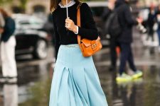 21 a catchy look with a black top and a white shirt underneath, a blue wide pleated midi, amber boots and an amber bag