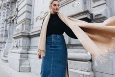 24 a black turtleneck, a blue denim midi with a side slit, a neutral scarf and black booties