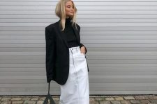 28 a trendy winter outfit with a black turtleneck and an oversized blazer, a white denim midi, snakeskin print boots and a black bag