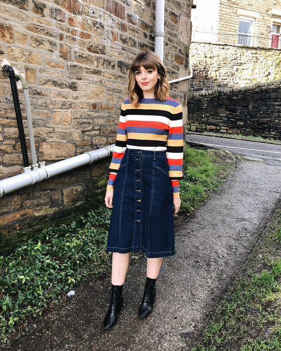 a pretty outfit with a bold striped top, a navy denim A-line midi, black boots feels like 70s