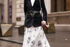 With black and white floral printed maxi dress, black, white and brown leather bag and black leather lace up low heeled boots