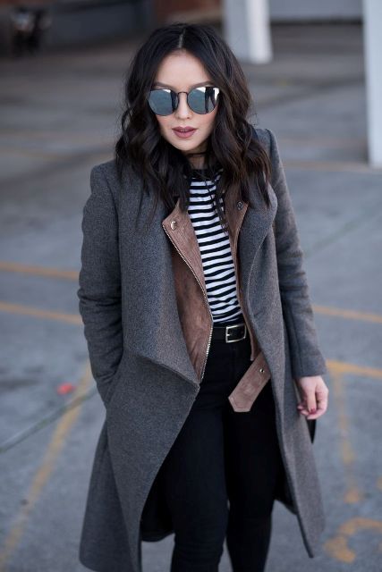 With black and white striped shirt, black belt, mirrored sunglasses and black skinny pants