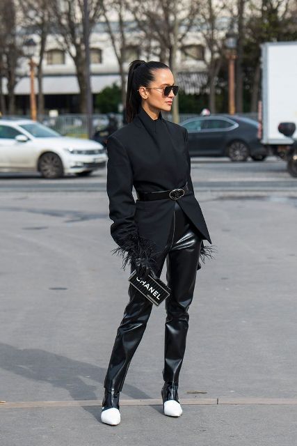 With black blazer, black leather belt, black and white zip boots and labeled clutch