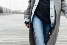 With black long sweater, distressed jeans and boots