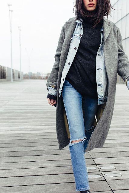 With black long sweater, distressed jeans and boots