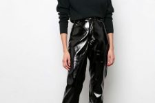 With black loose turtleneck sweater and black patent leather sock boots