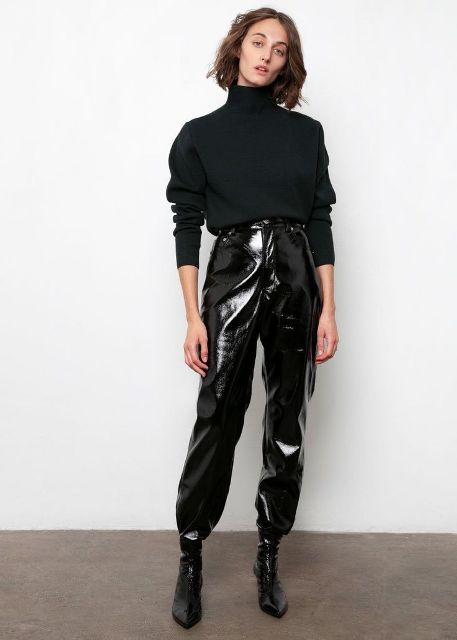With black loose turtleneck sweater and black patent leather sock boots