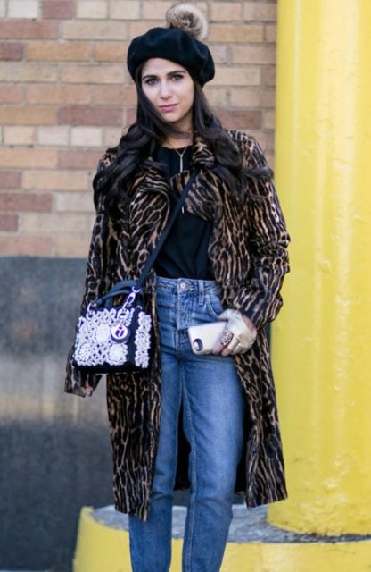 With black shirt, leopard printed knee length coat, navy blue and pale pink bag and jeans