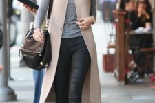 With black skinny pants, black leather heeled boots, leather bag and sunglasses