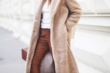 With brown hat, white sweater, brown cropped trousers, white sneakers and brown box bag