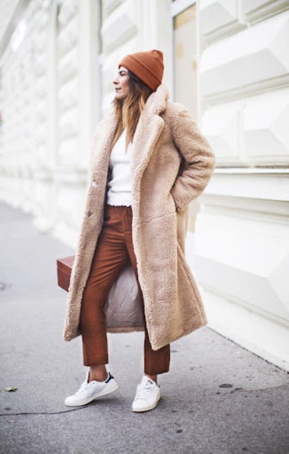 With brown hat, white sweater, brown cropped trousers, white sneakers and brown box bag