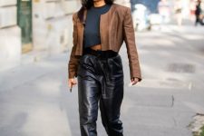 With dark gray cropped t-shirt, brown collarless jacket and black boots