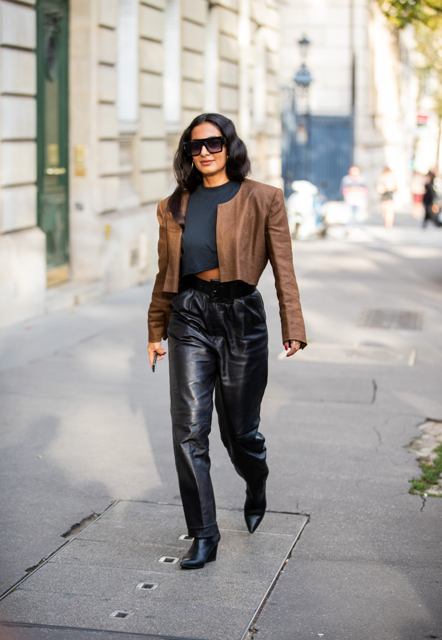 With dark gray cropped t-shirt, brown collarless jacket and black boots
