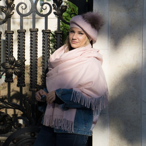 With denim jacket, jeans and pale pink fringe scarf