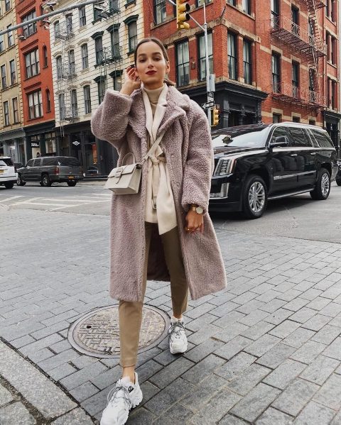 With gray turtleneck, beige belted blazer, trousers, light gray crossbody bag and white sneakers