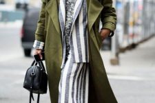 With gray turtleneck sweater, white and gray striped maxi skirt, black leather bag and black patent leather high heeled boots