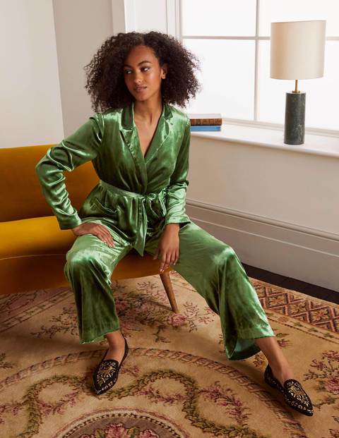 With green velvet trousers and printed flat shoes