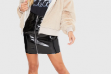 With labeled t-shirt, black patent leather zip front mini skirt and black lace up platform ankle boots