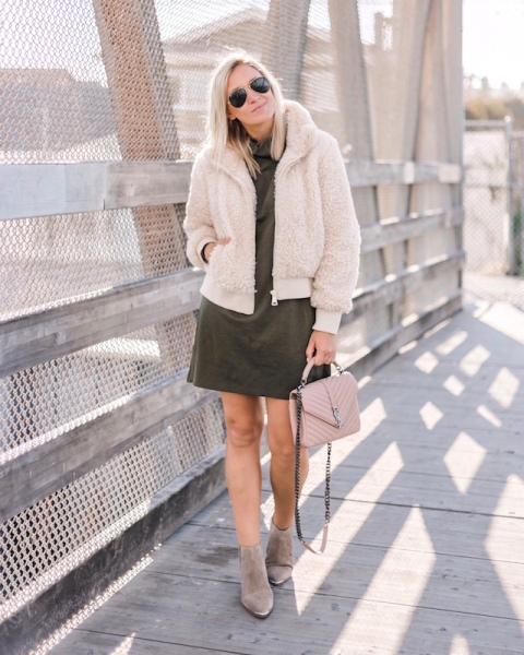 With olive green mini dress, sunglasses, pale pink chain strap bag and gray suede ankle boots