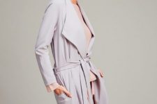 With pale pink blouse, pale pink pants and light gray belted trench coat