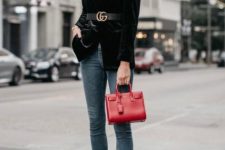 With sunglasses, skinny jeans, red leather mini bag and black pumps