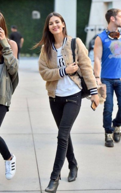 With white labeled t shirt, black skinny jeans, black backpack and black leather boots