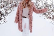 With white pom pom hat, beige loose sweater, white skinny pants, black embellished belt and pale pink mid calf flat boots