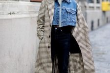 With white shirt, navy blue jeans, black embellished boots, pale pink bag and checked midi coat