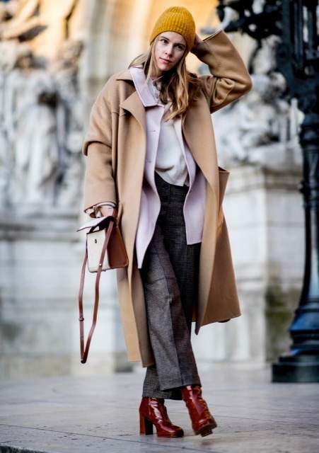 With white shirt, tweed trousers, brown and white bag, marsala patent leather boots and orange hat