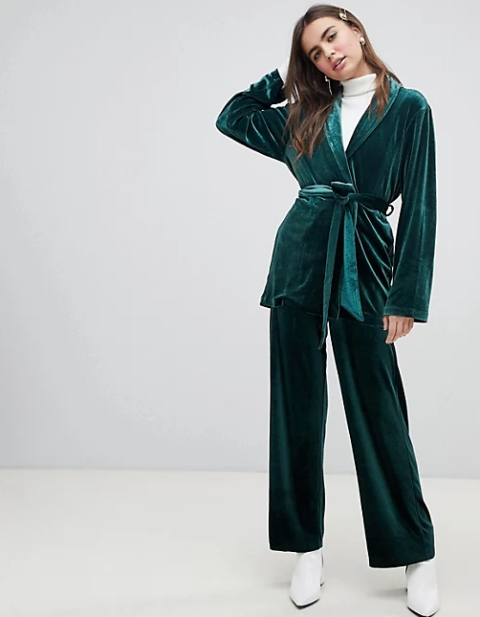 With white turtleneck, emerald green loose pants and white leather heeled boots