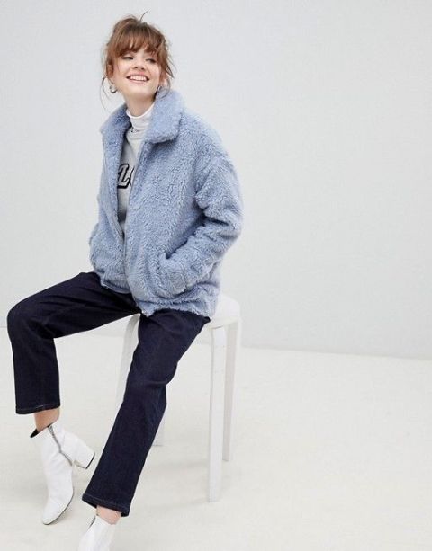 With white turtleneck, labeled sweatshirt, navy blue jeans and white low heeled ankle boots
