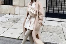 With white turtleneck, white long blazer, leggings, white sneakers, beige bag and pastel colored maxi coat
