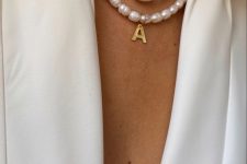 a baroque pearl necklace with a monogram paired with a colorful naive one accented with large pealrs, too