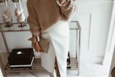 a beautiful and comfy winter work look with a beige chunky sweater, a white wrap midi skirt, white riding boots and a small clutch