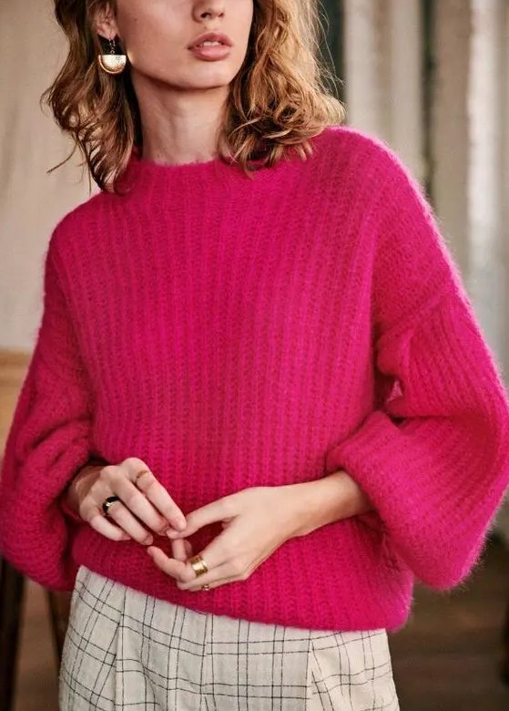 a beautiful chunky knit fuchsia sweater, neutral plaid trousers and statement earrings plus statement rings for a colorful work look