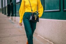 a beautiful jewel-toned look with a sunny yellow sweater, dark green trousers, amber boots and a black and green bag