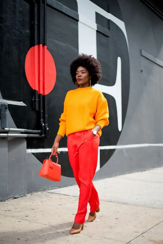 a bold look with a yellow chunky sweater, red trousers, orange shoes and an orange bag will raise your mood on a gloomy day