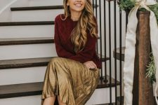 a burgundy patterned sweater, a gold pleated midi, black heels will do for both a party and an office