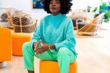 a colorful outfit with a turquoise turtleneck sweater, green trousers and emerald sneakers is a great idea