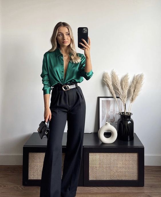 a green silk shirt, black high waisted trousers, a black bag and a metallic belt for a lovely Christmas work look