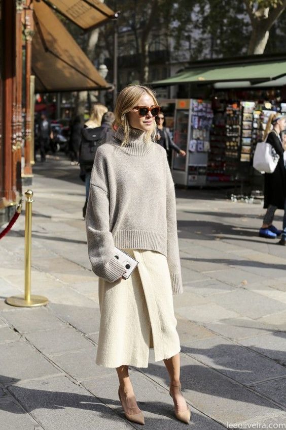 a grey oversized turtleneck sweater, a creamy fuzzy wrap midi skirt, tan shoes and a small clutch for a minimal winter work look