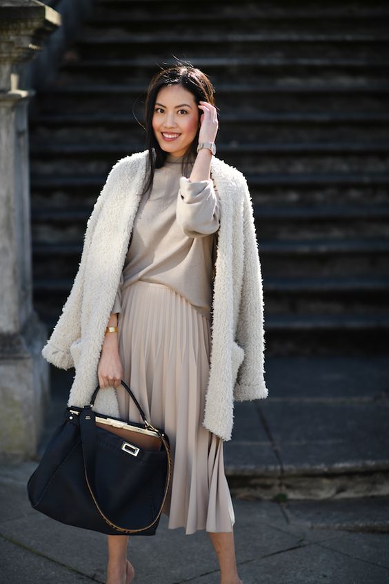a grey turtleneck, a grey pleated midi skirt, a creamy fuzzy cardigan, a black tote for a comfy work outfit in winter