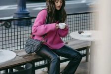 a hot pink sweater, black leather trousers, black booties, a saddle printed bag for a bright and cool winter work look