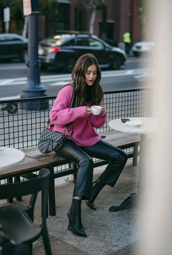 a hot pink sweater, black leather trousers, black booties, a saddle printed bag for a bright and cool winter work look