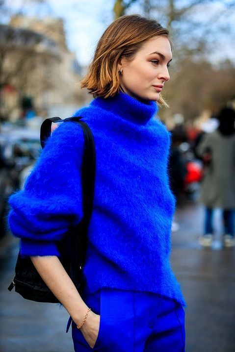 a jaw dropping electric blue outfit with a fuzzy sweater and matching trousers plus a black bag is wow