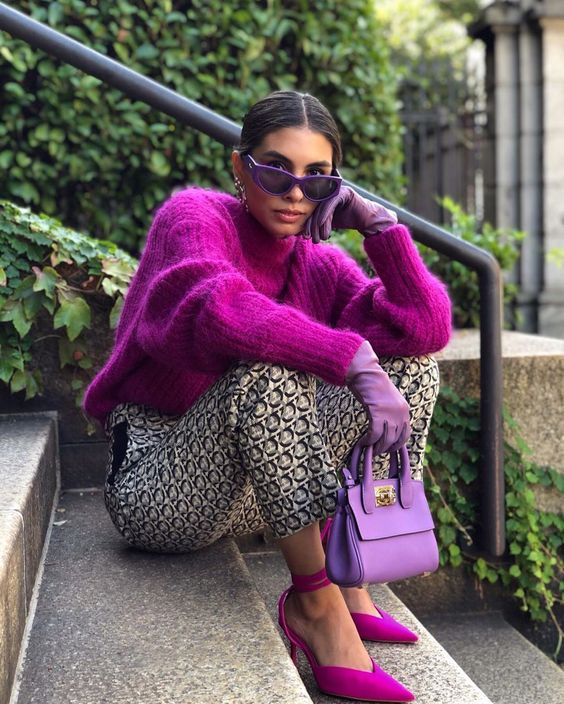 a lovely fuchsia chunky cropped sweater, printed trousers, fuchsia shoes and a purple bag for a statement