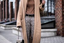 a monochromatic look with a brown turtleneck, grey plaid trousers, brown sneakers, a tan midi cardigan, a brown beanie and a bag